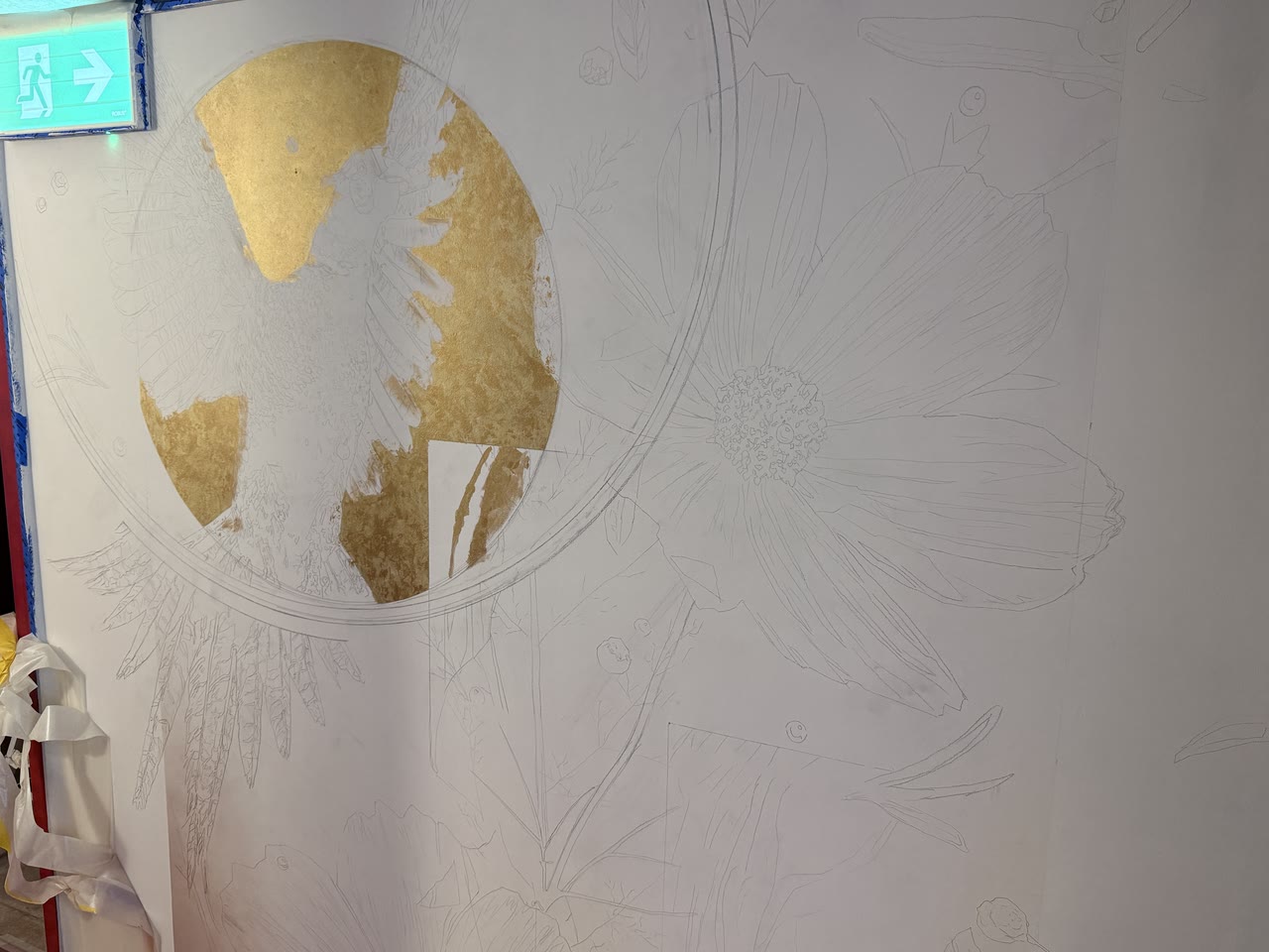 The mural begun as a pencil outline with a disc of gold leaf.