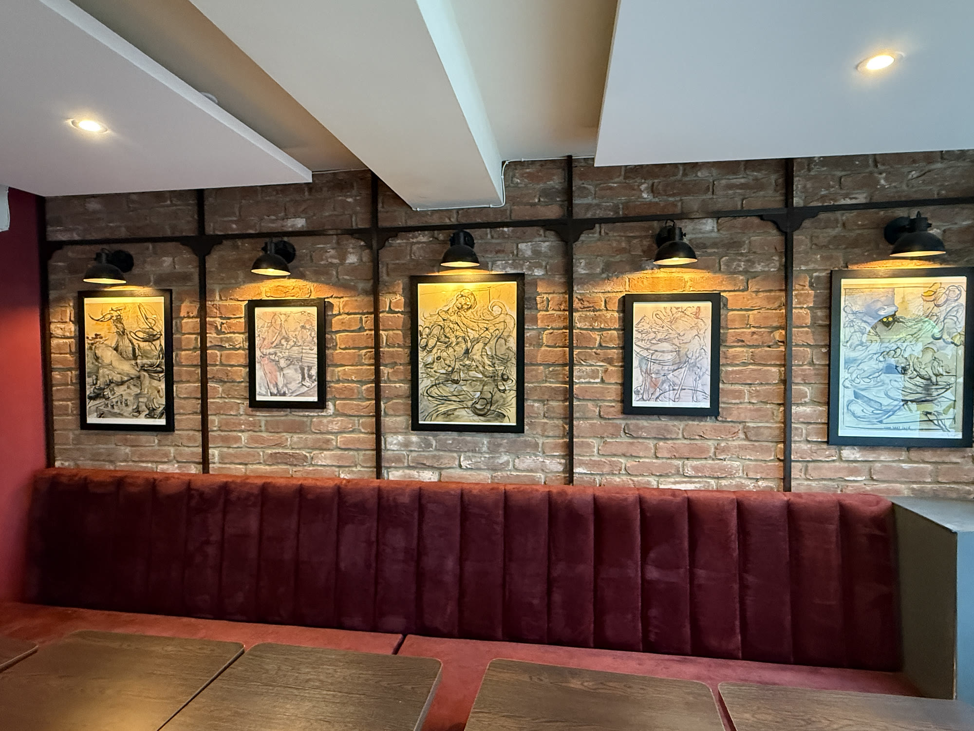 Feather's dining room during the fit-out: the red herringbone bar, exposed brick wall and walnut chairs.